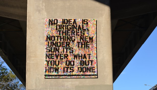 a painting on a concrete pillar of an overpass, words, No idea is original there's nothing new under the sun, it's never what you do but how you do it. 