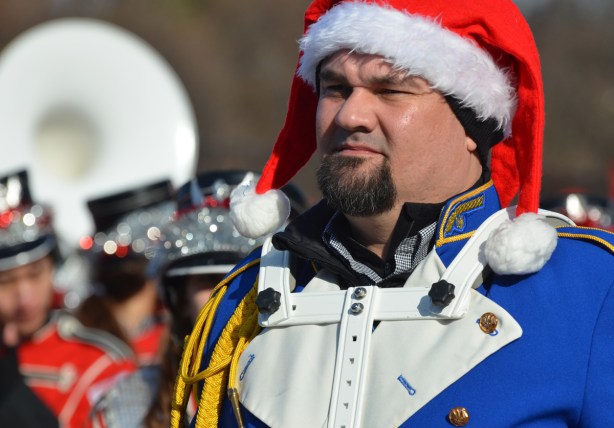 Santa Claus Parade musician, band member wearing red and white Santa Claus hat