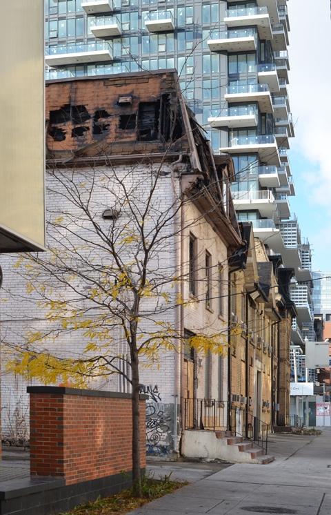 row of old brick houses at 79 through to 85 Shuter Street where a fire has recently partially destroyed the upper levels and roofs 