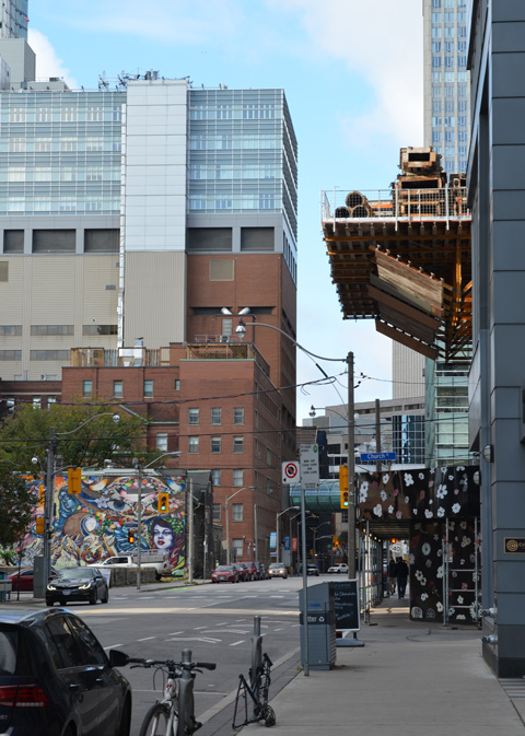 looking west on Shuter street at Church, St. Mikes hospital, construction at the NE corner of Shuter & Church, mural by parking lot 