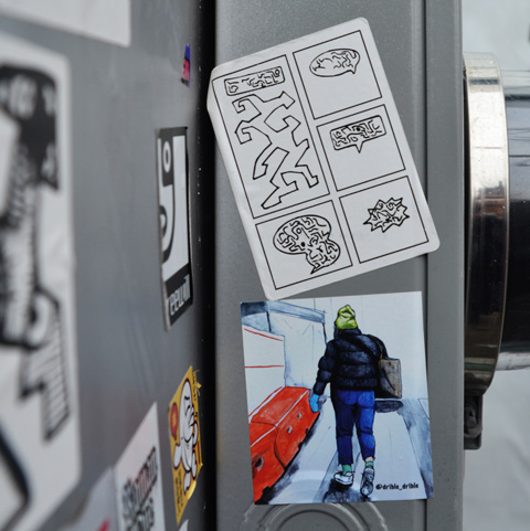 two stickers on metal, the lower one is by drible drible