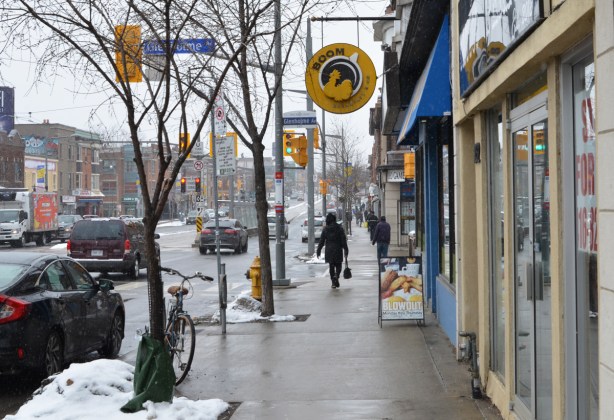 looking west on St. Clair approaching Glenholme, people on sidewalk, traffic lights, Boom restaurant, other store fronts