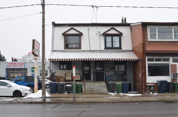two storey semi divided house beside Dufferin Bloor auto shop, bus stop in front,