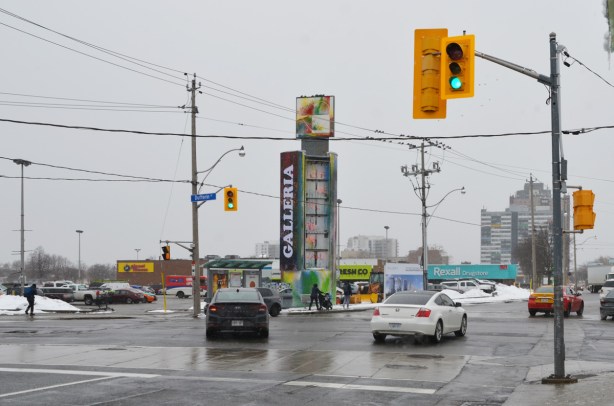 looking west on Dupont at Dufferin, old Galleria sign, parking lot, traffic lights, plaza