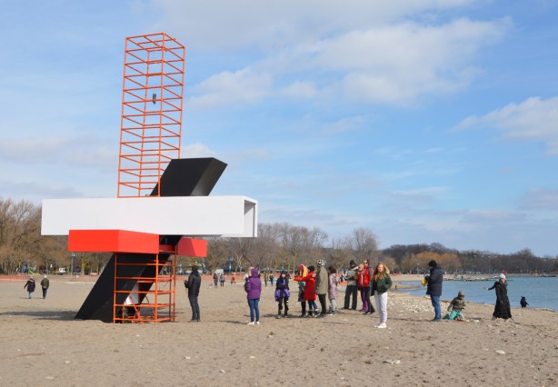 people lined up to take a look inside a portion of art installation at Woodbine Beach 