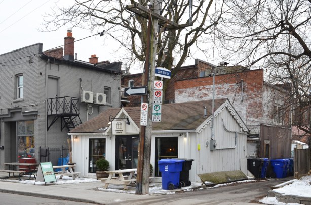 small house at the corner of a street and an alley, now a cafe