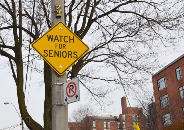 yellow traffic warning sign that says watch for seniors 
