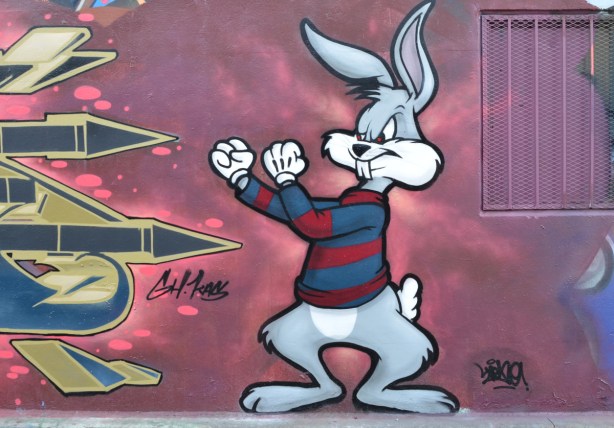 part of a street art mural of Bugs Bunny with his fists up and ready to fight 