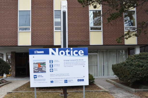 development notice on the front yard of a commercial (office) building from the 1970s 