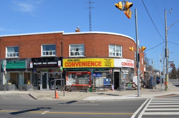 Donlands convenience store, a 2 storey brick building on the corner of an intersection, with a rounded wall 