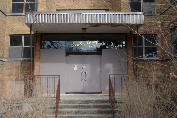 closer look at closed and boarded up front doors of Dudley Court 