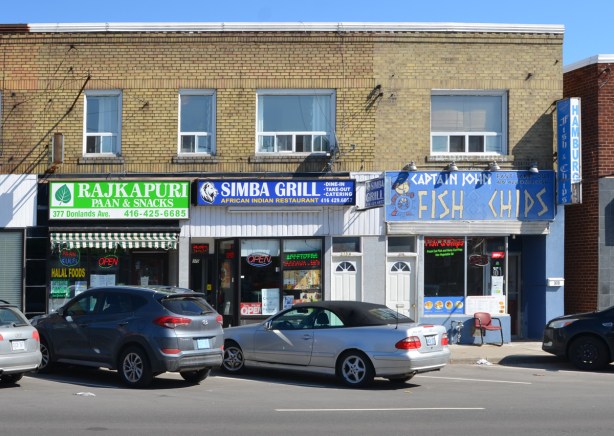 3 restaurants on a street, an Indian Paan and snack plce, an Africa Indian restaurant called Simba, and a fish and chip restaurant