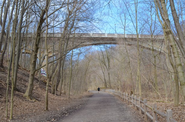 Governors Bridge, where Governors Road passes over the Beltline trail, early spring, no leaves on trees, one person jogging on the trail, path,
