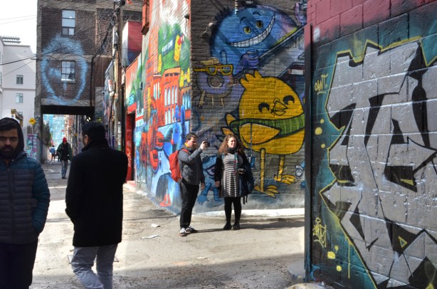 people in graffiti alley