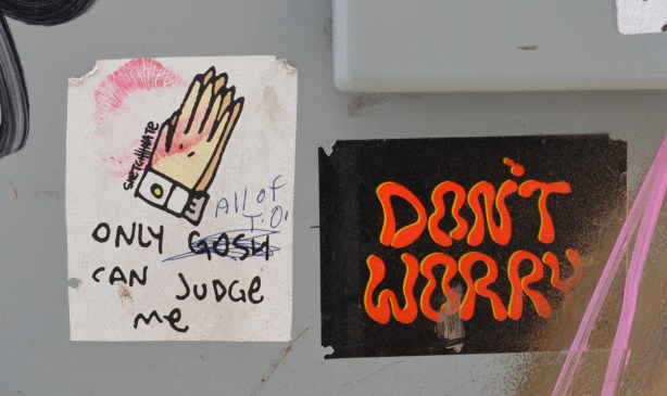 two stickers, one says don't worry, the other is a pair of praying hands and the words only gosh can judge me, by sketch nate. Someone has crossed out gosh and written all of T O 
