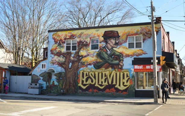 Leslieville mural by elicser of a man sitting under o tree in autumn