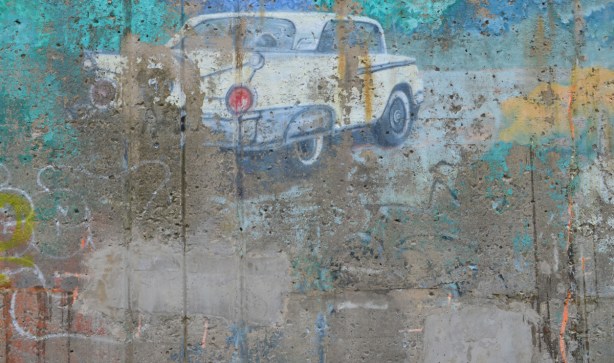 old faded mural of a small white car