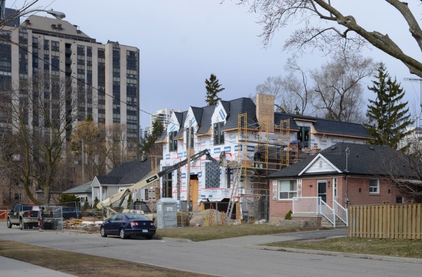 large new house being built in Willowdale, on Maplehurst Ave., in place of a small bungalow like the house beside it 