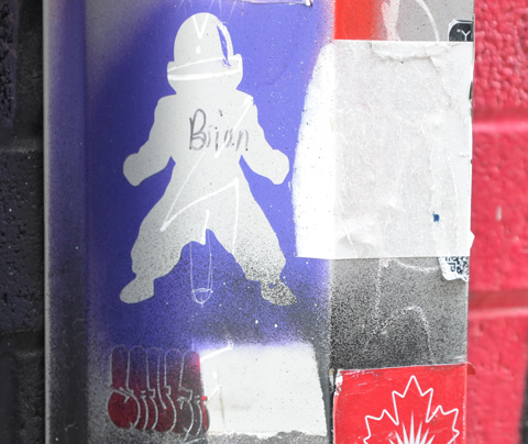 an astronaut shaped slap graffiti that someone has written the name Brian on