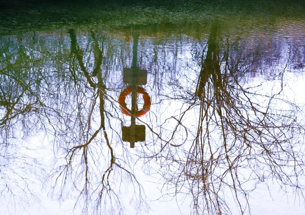 reflections of lifesaving equipment beside the Wilket Creek