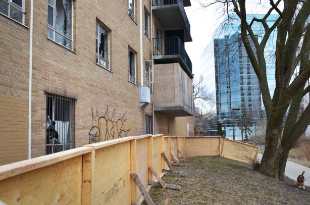 old ready for demolition with newer glass buildings in the background building 
