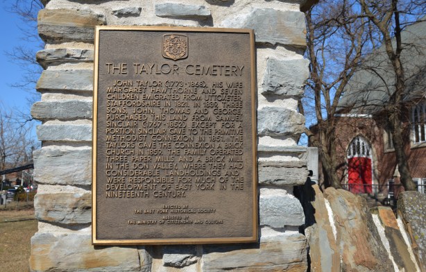 bronze plaque on a stone wall, Taylor cemetery, erected by the East York historical society gives rough outline of the history of the Taylor family here