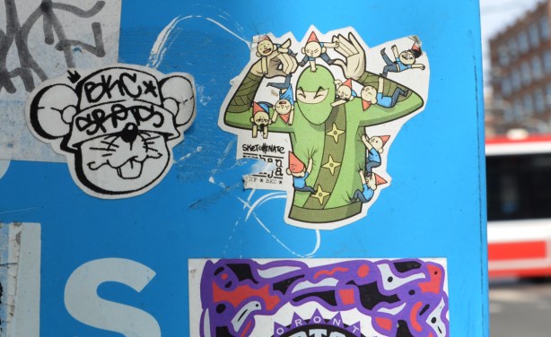 urban ninja squadron sticker, in colour, on a blue background - side of a Bell phone booth 