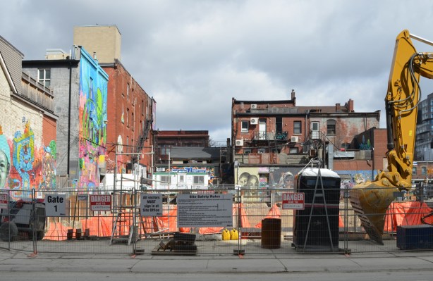 construction site on Richmond street backing onto Graffiti Alley with lots of walls covered with street art and murals 