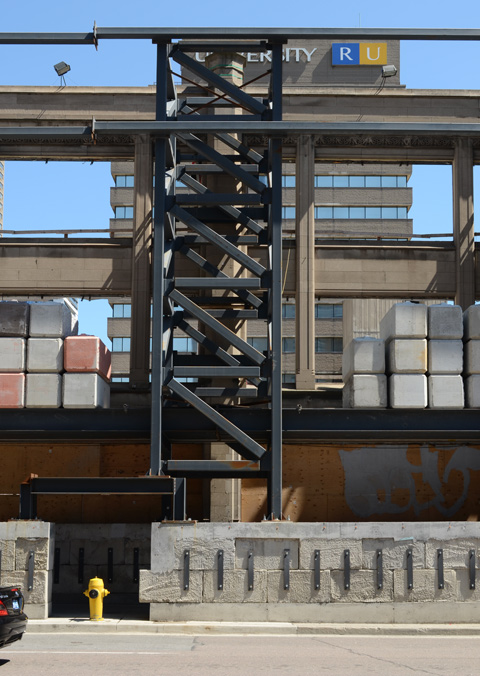 metal framework and concrete weights that are used to shore up the walls of a facade being saved during redevelopment 