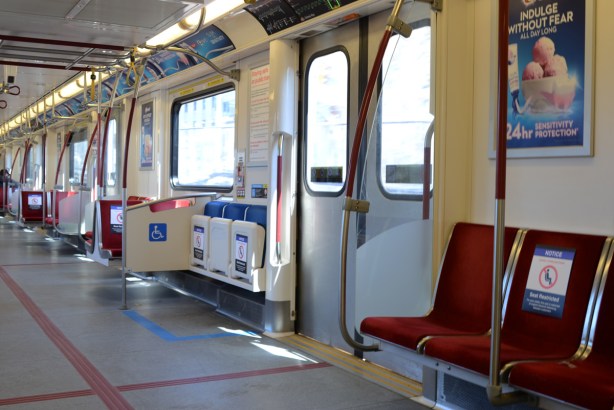 empty seats on TTC subway car, signs on seats saying do not sit here, social distancing measure re covid-19