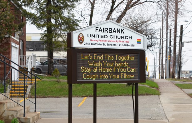 sign outside Fairbank United Church, in lights, that says Let's end this together, Wash your hands. Stay at home if you can. Cough into your elbow. 