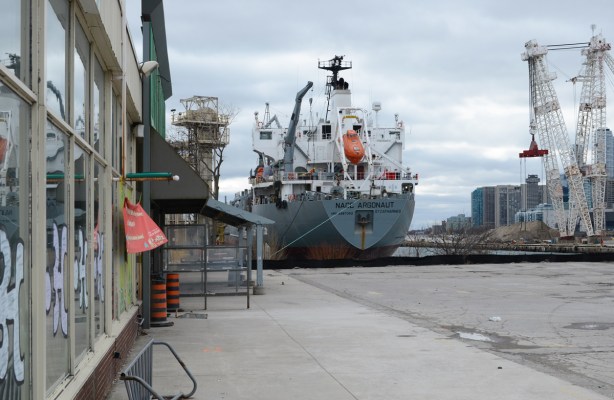 back of a large laker boat parked beside an empty parking lot 