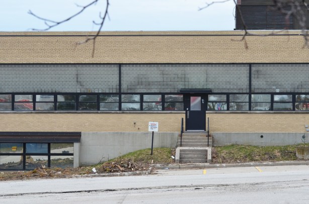 east side of old IBM building at Don Mills and Eglinton, low rise yellow brick, horizontal windows, empty and ready for demolition
