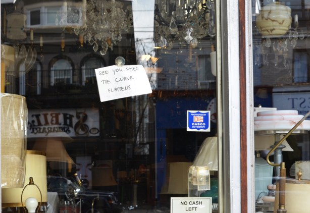 a sign on the glass door of a store selling old lights and lamps that says 