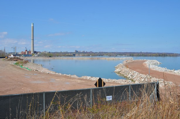filling in part of Lake Ontario, walls of rocks with dirt between them 