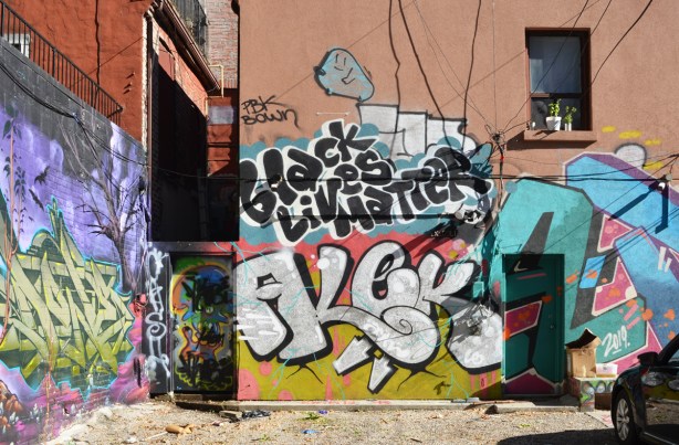 Graffiti on a wall in Graffiti Alley including the words Black Lives Matter