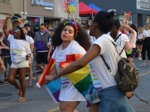 women dancing in the street, pride parade