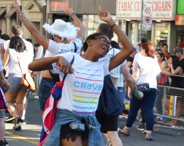 women dancing in the street, pride parade