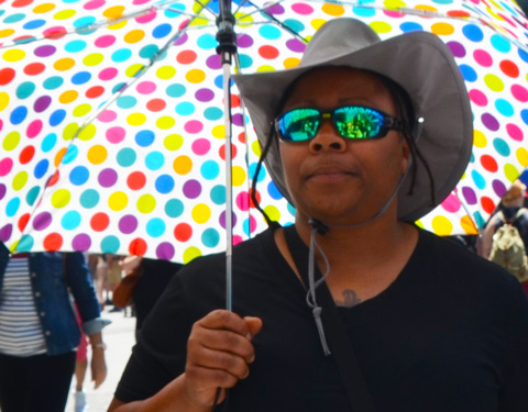 carrying a big polka dot umbrella