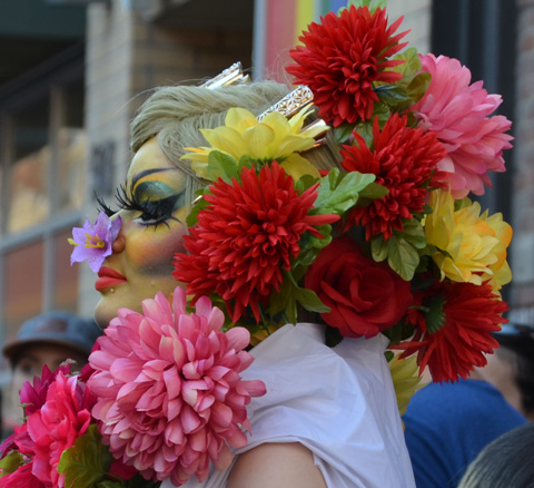 flowers entirely converng back of person's head and neck, one on nose too