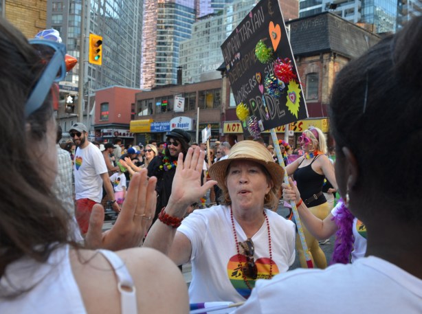high fives, pride parade