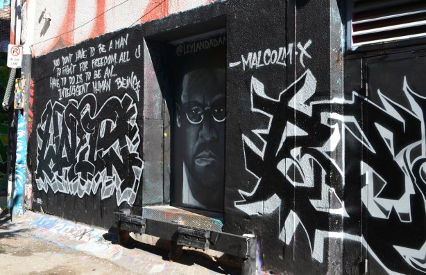 mural dedicated to Malcom X with his portrait and one of his quotes
