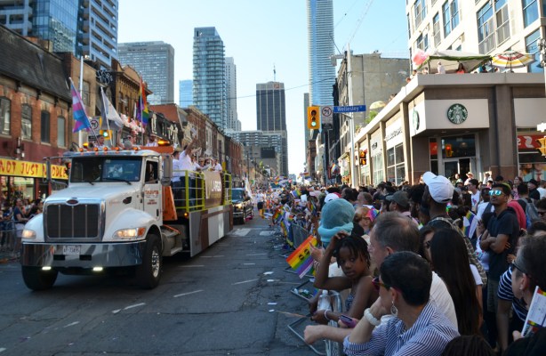 truck pulling float down Yonge Street for Pride parade 