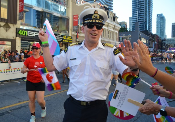 man in uniform in pride parade 