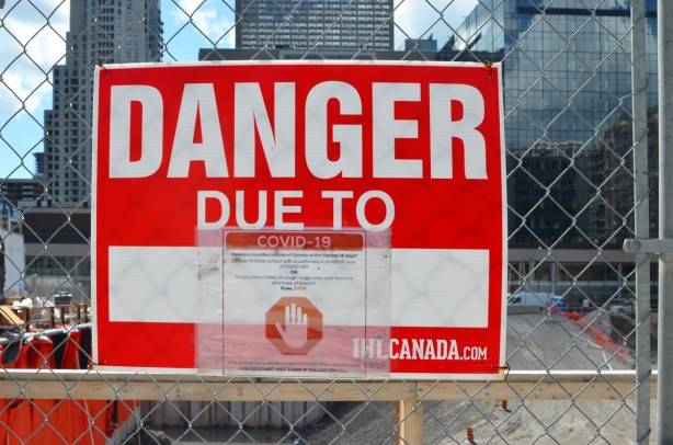 and red and white danger due to sign, danger due to covid-19