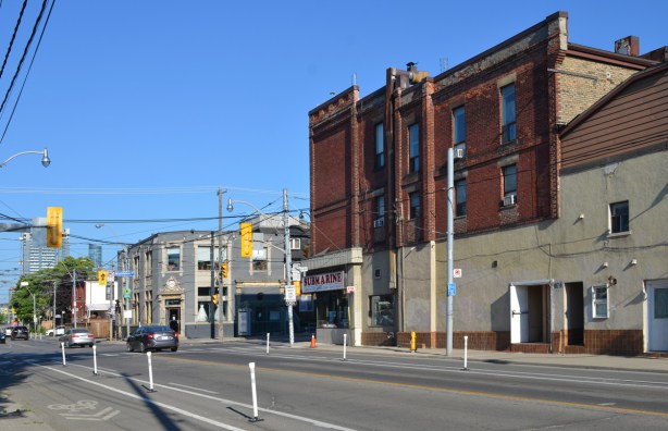 intersection of Broadview and Dundas East, looking west along Dundas towards Broadview. Large old red brick building on the north east corner