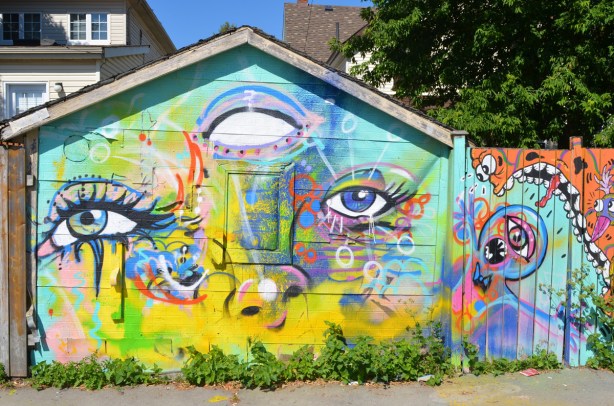a mural on a garage door by anya mielniczek of a face