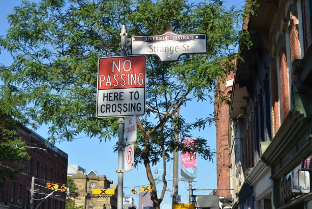 street sign, Riverside District, Strange street, with a a no passing sign beside it