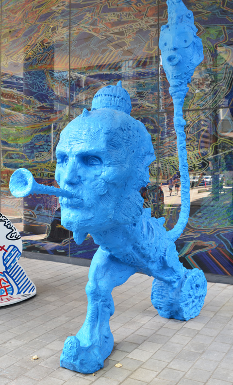 stargate sculpture series, redpath ave in toronto, public art, yellow and blue alien figures and two glass murals - blue alien blowing a long horn