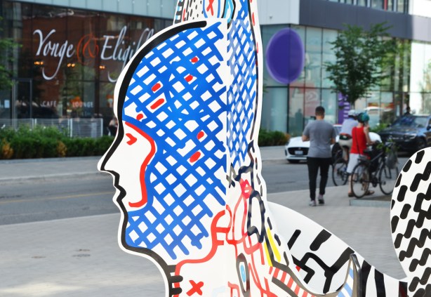 stargate sculpture series, redpath ave in toronto, public art, yellow and blue alien figures and two glass murals